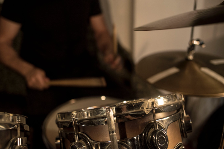 Man playing on modern drum kit.