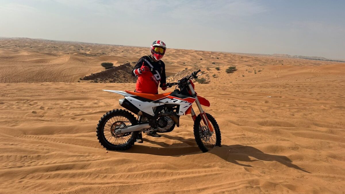 What makes dirt biking in the Dubai desert an exhilarating adventure?