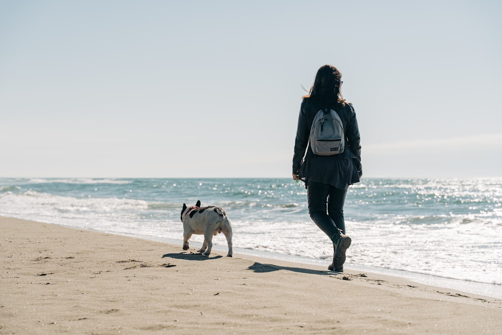  A woman walking a white dog