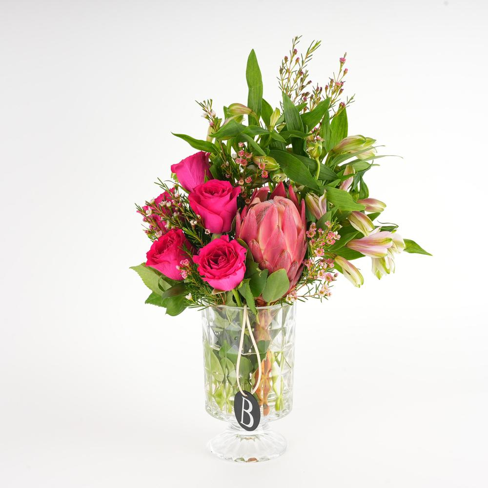 A beautiful flower arrangement with roses and other elements