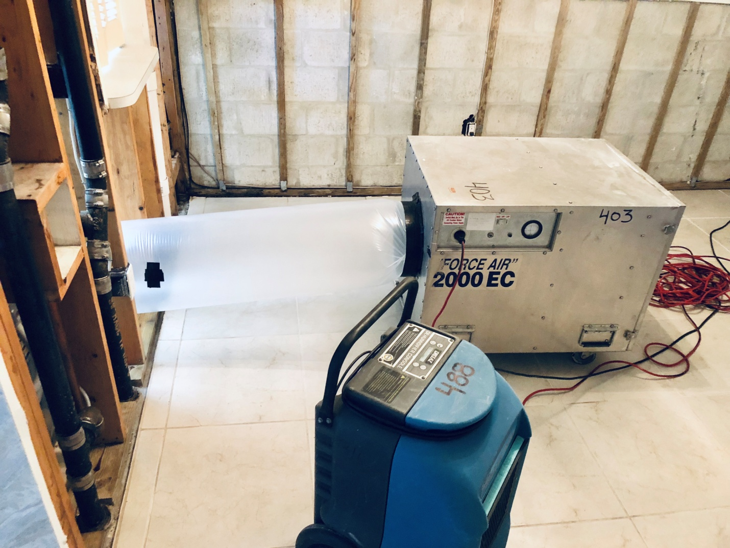 Equipment dehumidifying a house after water damage