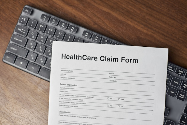 High-angle shot of a healthcare claim form on a keyboard